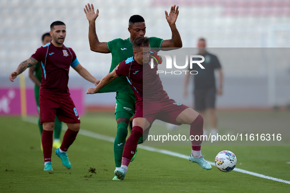 In Ta' Qali, Malta, on September 27, 2024, Thiago Espindola de Paula of Gzira United is challenged from the back by Kemar Reid of Floriana d...