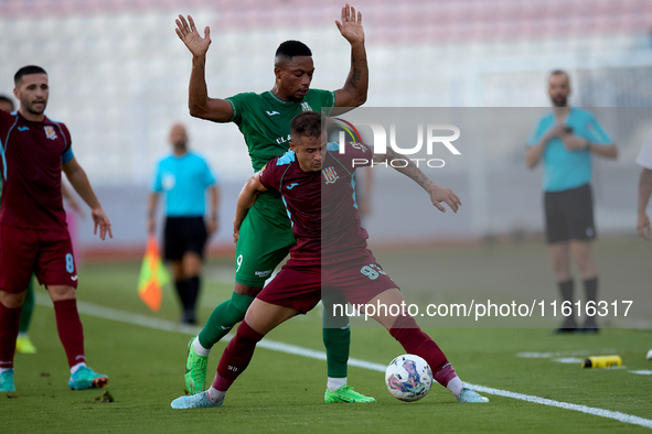 Thiago Espindola de Paula of Gzira United is challenged from the back by Kemar Reid of Floriana during the Malta 360 Sports Premier League s...