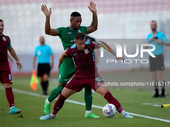 Thiago Espindola de Paula of Gzira United is challenged from the back by Kemar Reid of Floriana during the Malta 360 Sports Premier League s...