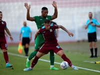 Thiago Espindola de Paula of Gzira United is challenged from the back by Kemar Reid of Floriana during the Malta 360 Sports Premier League s...