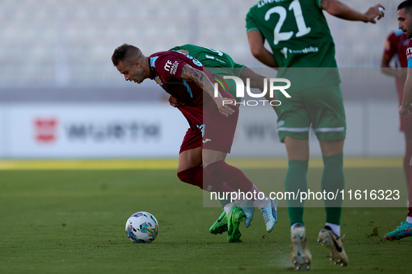 Thiago Espindola de Paula (L) of Gzira United is in action during the Malta 360 Sports Premier League soccer match between Floriana and Gzir...