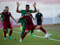 In Ta' Qali, Malta, on September 27, 2024, Thiago Espindola de Paula of Gzira United is challenged from the back by Kemar Reid of Floriana d...