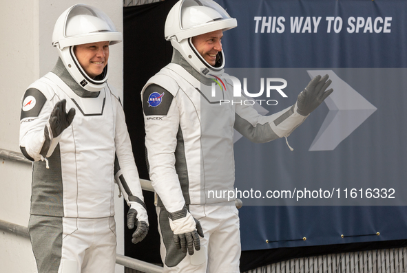 Astronaut Nick Hague (NASA), right, and Cosmonaut Alexander Gorbunov (Roscosmos), left, during the traditional ''walkout,'' leave the Astron...