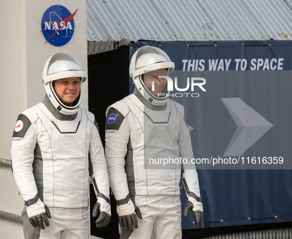 Astronaut Nick Hague (NASA), right, and Cosmonaut Alexander Gorbunov (Roscosmos), left, during the traditional ''walkout,'' leave the Astron...