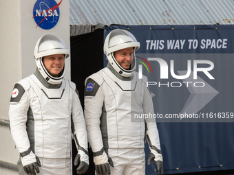 Astronaut Nick Hague (NASA), right, and Cosmonaut Alexander Gorbunov (Roscosmos), left, during the traditional ''walkout,'' leave the Astron...