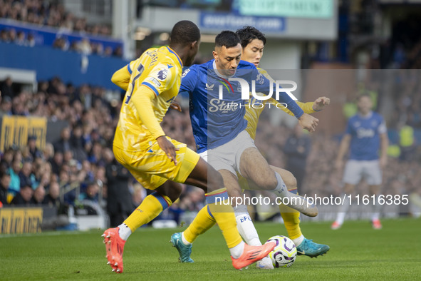 Dwight McNeil #7 of Everton F.C. is tackled by Tyrick Mitchell #3 of Crystal Palace F.C. during the Premier League match between Everton and...