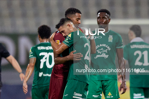 Thaylor Aldama of Gzira United and Nicolas Marias Garcia of Floriana hug each other after the Malta 360 Sports Premier League soccer match b...