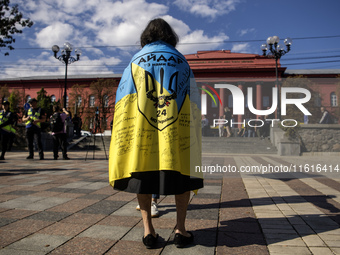 Ukrainians attend a march marking the upcoming Defenders of Ukraine Day in Kyiv, Ukraine, on September 28, 2024 (