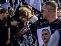 Ukrainians hold portraits of a fallen Ukrainian soldier during a march marking the upcoming Defenders of Ukraine Day in Kyiv, Ukraine, on Se...