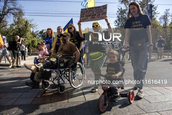 Ukrainians attend a march marking the upcoming Defenders of Ukraine Day in Kyiv, Ukraine, on September 28, 2024 