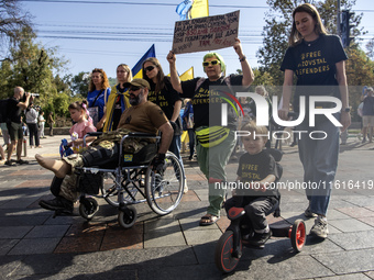 Ukrainians attend a march marking the upcoming Defenders of Ukraine Day in Kyiv, Ukraine, on September 28, 2024 (