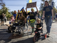 Ukrainians attend a march marking the upcoming Defenders of Ukraine Day in Kyiv, Ukraine, on September 28, 2024 (