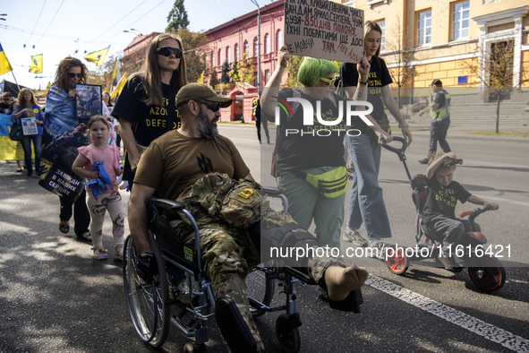 Ukrainians attend a march marking the upcoming Defenders of Ukraine Day in Kyiv, Ukraine, on September 28, 2024 