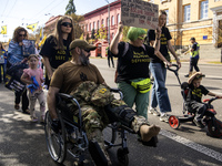 Ukrainians attend a march marking the upcoming Defenders of Ukraine Day in Kyiv, Ukraine, on September 28, 2024 (