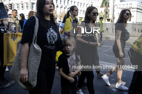 Ukrainians attend a march marking the upcoming Defenders of Ukraine Day in Kyiv, Ukraine, on September 28, 2024 