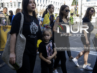 Ukrainians attend a march marking the upcoming Defenders of Ukraine Day in Kyiv, Ukraine, on September 28, 2024 (