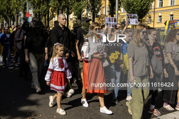 Ukrainians attend a march marking the upcoming Defenders of Ukraine Day in Kyiv, Ukraine, on September 28, 2024 