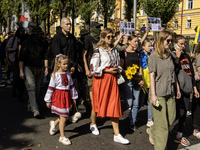 Ukrainians attend a march marking the upcoming Defenders of Ukraine Day in Kyiv, Ukraine, on September 28, 2024 (