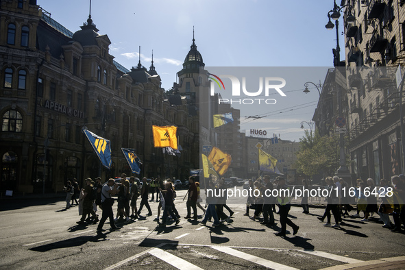 Ukrainians attend a march marking the upcoming Defenders of Ukraine Day in Kyiv, Ukraine, on September 28, 2024 