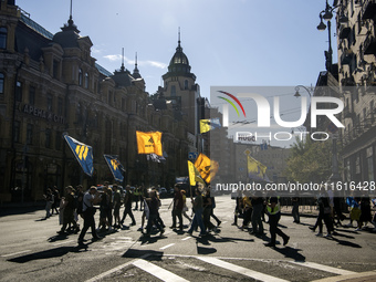 Ukrainians attend a march marking the upcoming Defenders of Ukraine Day in Kyiv, Ukraine, on September 28, 2024 (