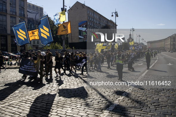 Ukrainians attend a march marking the upcoming Defenders of Ukraine Day in Kyiv, Ukraine, on September 28, 2024 