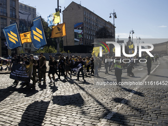 Ukrainians attend a march marking the upcoming Defenders of Ukraine Day in Kyiv, Ukraine, on September 28, 2024 (