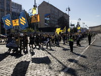 Ukrainians attend a march marking the upcoming Defenders of Ukraine Day in Kyiv, Ukraine, on September 28, 2024 (