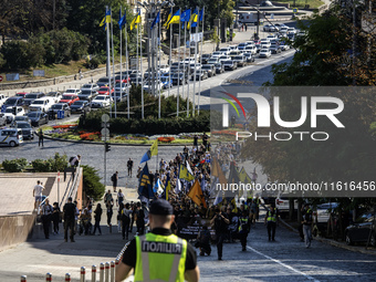 Ukrainians attend a march marking the upcoming Defenders of Ukraine Day in Kyiv, Ukraine, on September 28, 2024 (