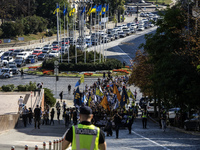 Ukrainians attend a march marking the upcoming Defenders of Ukraine Day in Kyiv, Ukraine, on September 28, 2024 (