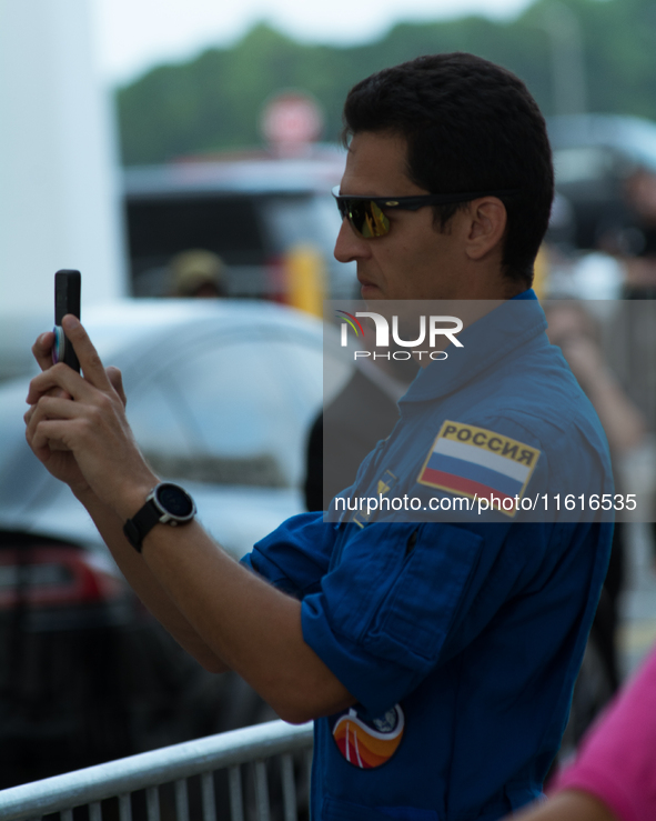 A Russian astronaut takes a cell phone video of the Crew 9 walkout 