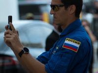 A Russian astronaut takes a cell phone video of the Crew 9 walkout (