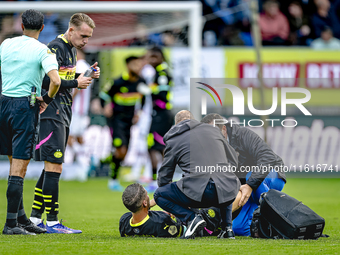 PSV Eindhoven midfielder Joey Veerman gets injured during the match between Willem II and PSV at the Koning Willem II stadium for the Dutch...