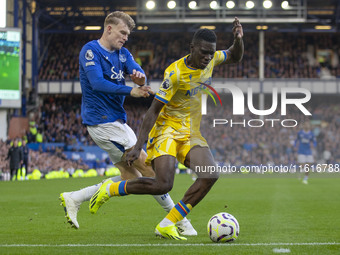 Ismaila Sarr #7 of Crystal Palace F.C. is tackled by the opponent during the Premier League match between Everton and Crystal Palace at Good...