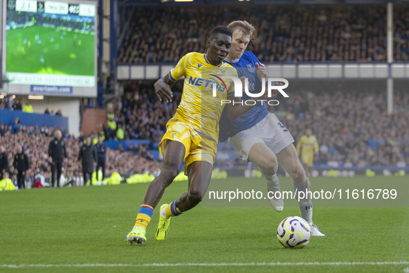 Ismaila Sarr #7 of Crystal Palace F.C. is tackled by an opponent during the Premier League match between Everton and Crystal Palace at Goodi...