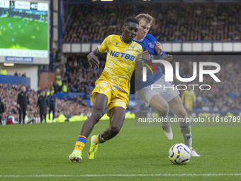 Ismaila Sarr #7 of Crystal Palace F.C. is tackled by an opponent during the Premier League match between Everton and Crystal Palace at Goodi...