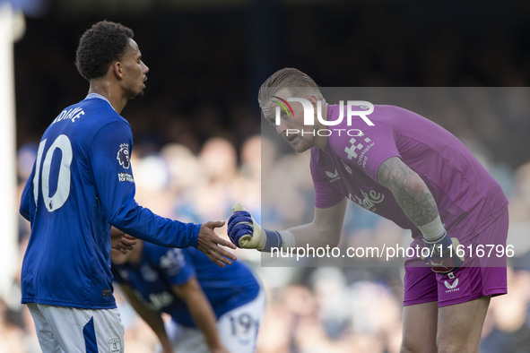 Jordan Pickford #1 (GK) of Everton F.C. and Iliman Ndiaye #10 of Everton F.C. during the Premier League match between Everton and Crystal Pa...