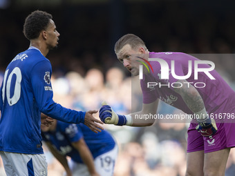 Jordan Pickford #1 (GK) of Everton F.C. and Iliman Ndiaye #10 of Everton F.C. during the Premier League match between Everton and Crystal Pa...