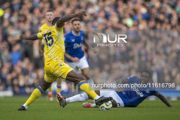 Jeffrey Schlupp #15 of Crystal Palace F.C. is tackled by the opponent during the Premier League match between Everton and Crystal Palace at...