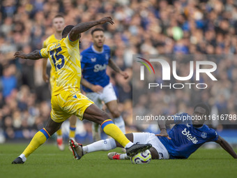 Jeffrey Schlupp #15 of Crystal Palace F.C. is tackled by the opponent during the Premier League match between Everton and Crystal Palace at...