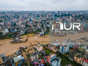 A drone view shows the Nakhu River flooding and affecting the riverbanks and homes during heavy rainfall in Lalitpur, Nepal, on September 28...