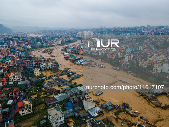 A drone view shows the Nakhu River flooding and affecting the riverbanks and homes during heavy rainfall in Lalitpur, Nepal, on September 28...