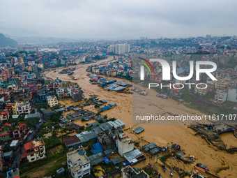 A drone view shows the Nakhu River flooding and affecting the riverbanks and homes during heavy rainfall in Lalitpur, Nepal, on September 28...