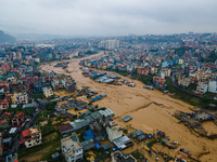 A drone view shows the Nakhu River flooding and affecting the riverbanks and homes during heavy rainfall in Lalitpur, Nepal, on September 28...