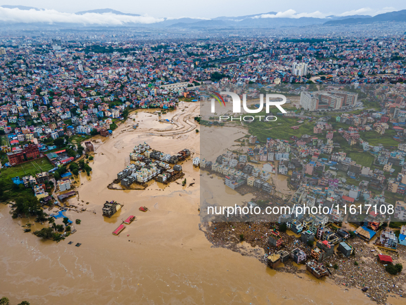 A drone view shows the Nakhu River flooding and affecting the riverbanks and homes during heavy rainfall in Lalitpur, Nepal, on September 28...