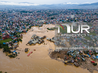 A drone view shows the Nakhu River flooding and affecting the riverbanks and homes during heavy rainfall in Lalitpur, Nepal, on September 28...