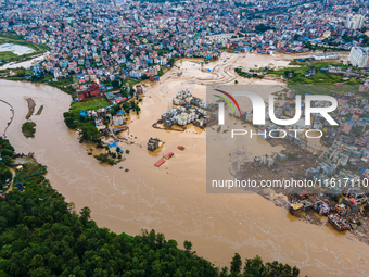 A drone view shows the Nakhu River flooding and affecting the riverbanks and homes during heavy rainfall in Lalitpur, Nepal, on September 28...