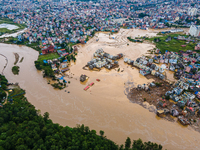 A drone view shows the Nakhu River flooding and affecting the riverbanks and homes during heavy rainfall in Lalitpur, Nepal, on September 28...