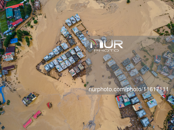 A drone view shows the Nakhu River flooding and affecting the riverbanks and homes during heavy rainfall in Lalitpur, Nepal, on September 28...