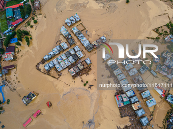 A drone view shows the Nakhu River flooding and affecting the riverbanks and homes during heavy rainfall in Lalitpur, Nepal, on September 28...