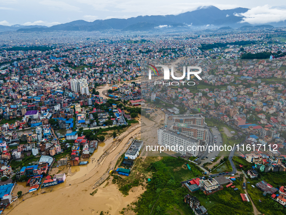 A drone view shows the Nakhu River flooding and affecting the riverbanks and homes during heavy rainfall in Lalitpur, Nepal, on September 28...